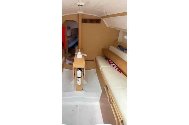 Slide: The Image of Interior of 2014 Beneteau FIRST 25 S sailboat, featuring seating and storage. - 17