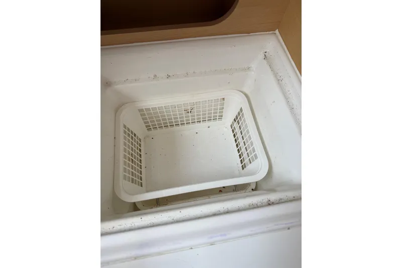 Slide: The Image of Storage compartment with basket inside a 2014 Beneteau FIRST 25 S sailboat. - 20