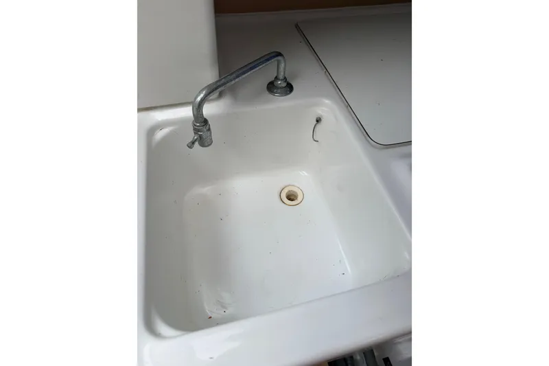Slide: The Image of White sink with metal faucet in 2014 Beneteau FIRST 25 S yacht. - 21