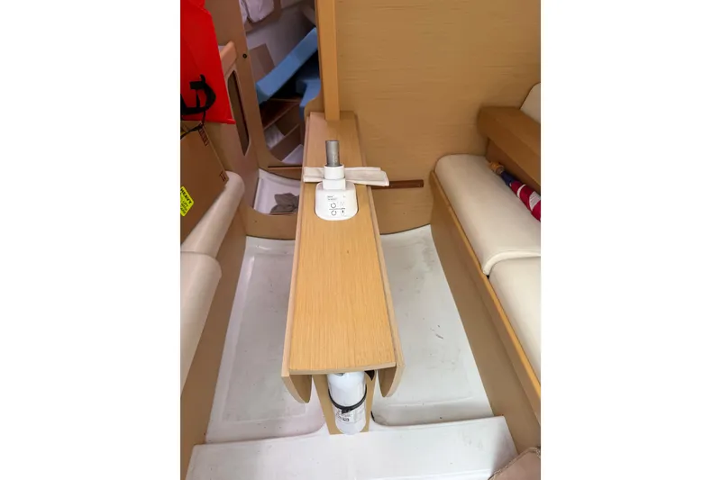 Slide: The Image of Interior of 2014 Beneteau FIRST 25 S sailboat, featuring wooden table and seating. - 25