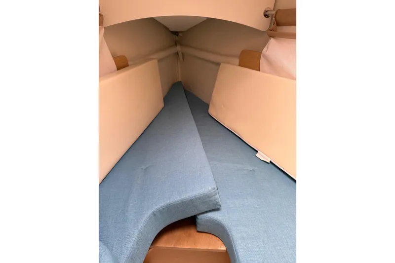 Slide: The Image of Interior cabin of 2014 Beneteau FIRST 25 S sailboat with blue cushions. - 28