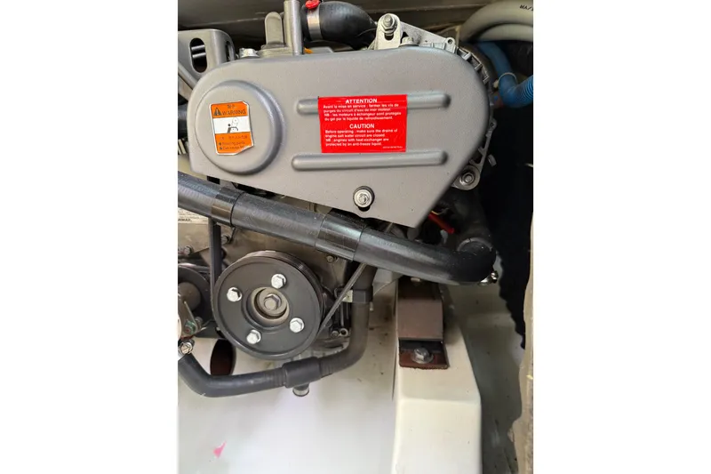 Slide: The Image of Engine compartment of a 2014 Beneteau FIRST 25 S sailboat, showing detailed components. - 32