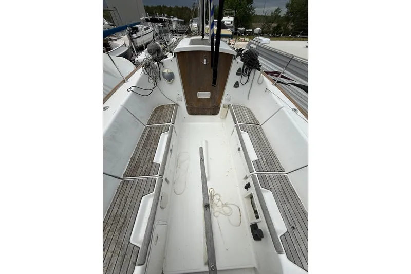 Slide: The Image of Cockpit of 2014 Beneteau FIRST 25 S sailboat with wooden seating and ropes. - 35