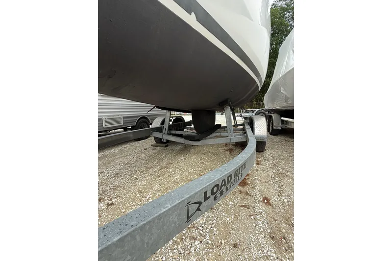 Slide: The Image of 2014 Beneteau FIRST 25 S sailboat on Load Rite trailer, parked on gravel. - 39