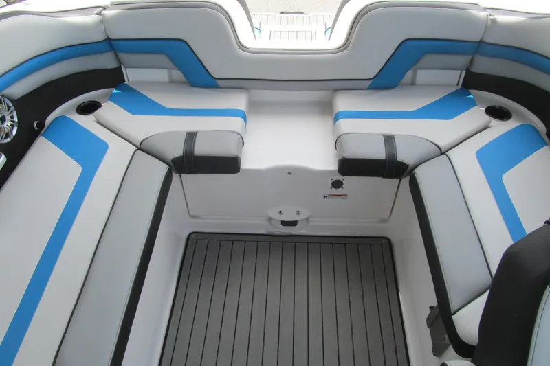 Slide: The Image of 2017 Yamaha Boats 242X E-Series interior with blue and gray seating and flooring. - 11