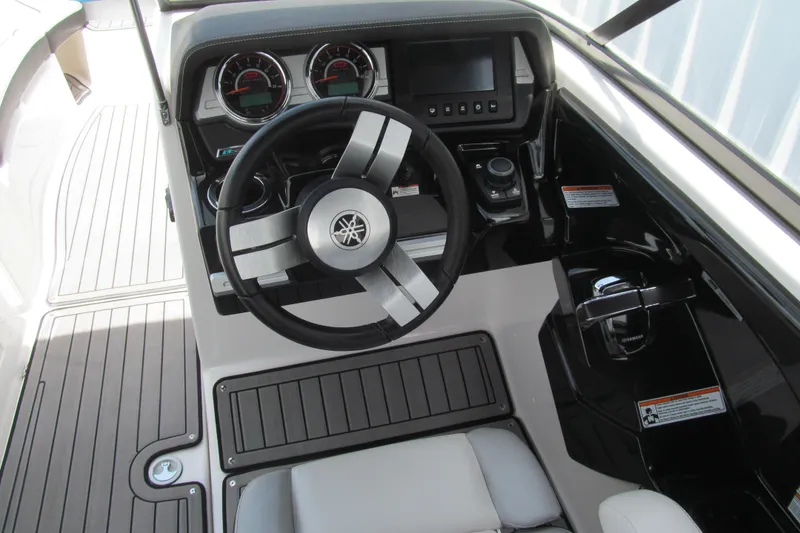 Slide: The Image of 2017 Yamaha Boats 242X E-Series dashboard with steering wheel and controls. - 4