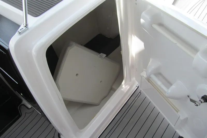 Slide: The Image of Storage compartment of 2017 Yamaha Boats 242X E-Series, featuring spacious interior and secure latch. - 6