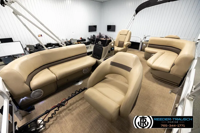 Slide: The Image of 2022 SUNTRACKER BASS BUGGY 18 DLX pontoon boat interior with beige seating and helm. - 10