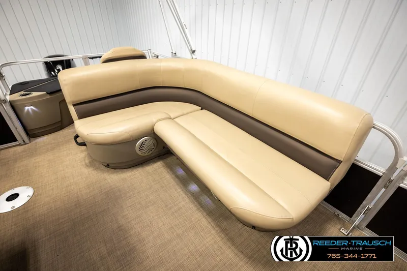 Slide: The Image of 2022 SUNTRACKER BASS BUGGY 18 DLX pontoon boat with beige seating and carpeted floor. - 20