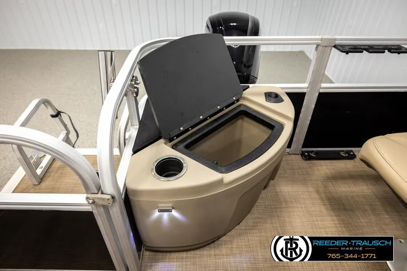 Slide: The Image of 2022 SUNTRACKER BASS BUGGY 18 DLX boat interior with storage compartment and cup holder. - 23