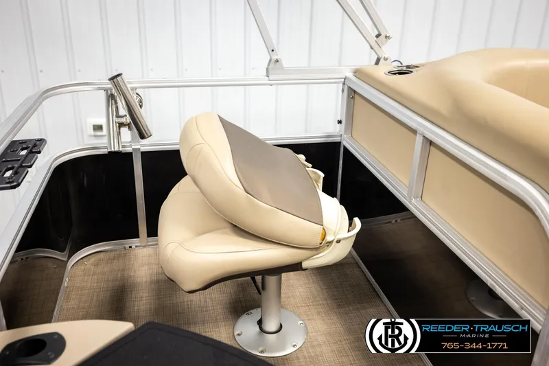 Slide: The Image of 2022 SUNTRACKER BASS BUGGY 18 DLX boat interior with beige seating and metal railing. - 24