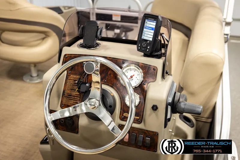 Slide: The Image of Steering console of 2022 SUNTRACKER BASS BUGGY 18 DLX with gauges and navigation system. - 26
