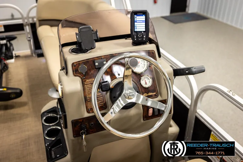 Slide: The Image of 2022 SUNTRACKER BASS BUGGY 18 DLX boat dashboard with steering wheel and controls. - 27