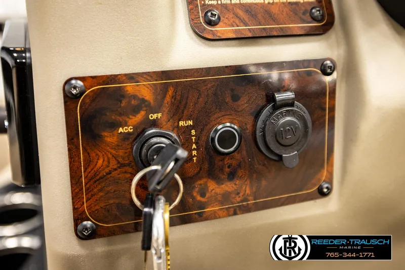 Slide: The Image of Control panel of 2022 SUNTRACKER BASS BUGGY 18 DLX with ignition and 12V outlet. - 28
