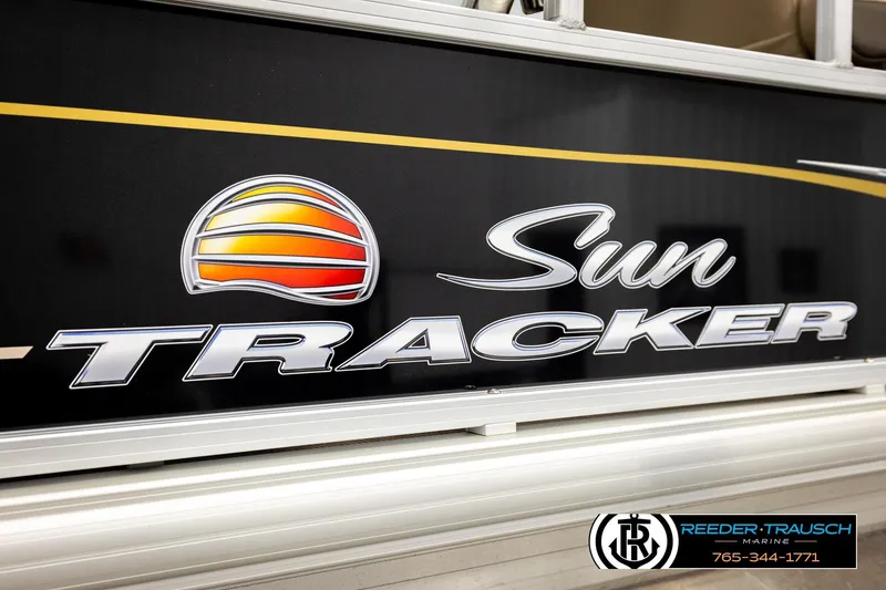 Slide: The Image of 2022 SUNTRACKER BASS BUGGY 18 DLX logo on boat exterior with dealership branding. - 54
