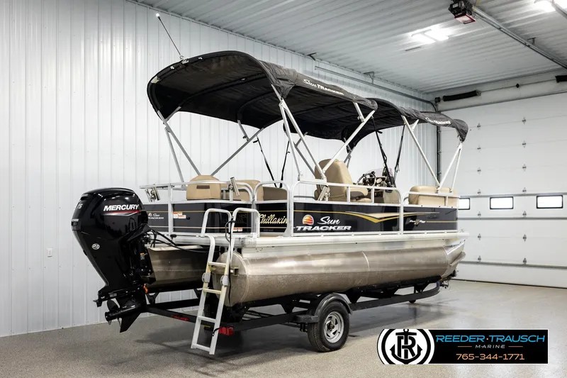 Slide: The Image of 2022 SUNTRACKER BASS BUGGY 18 DLX pontoon boat in indoor showroom. - 6