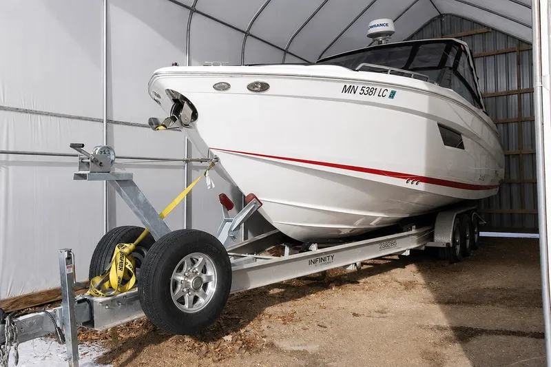 The Image of 2015 Cruisers Sport Series 328 Bow Rider on trailer in storage shed. - 0