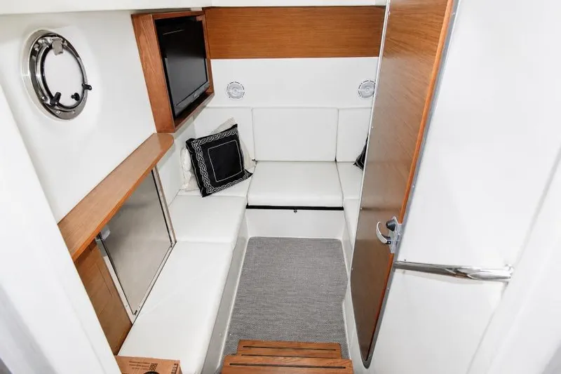 Slide: The Image of Interior cabin of 2015 Cruisers Sport Series 328 Bow Rider with seating and porthole. - 10