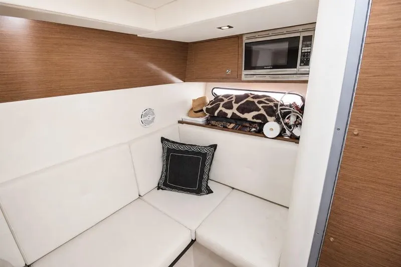 Slide: The Image of Interior of 2015 Cruisers Sport Series 328 Bow Rider with seating and microwave. - 11