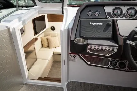 Slide: The Image of Manufacturer Provided Image: 2015 Cruisers Sport Series 328 Bow Rider interior with seating and Raymarine dashboard. - 18