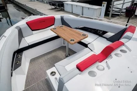 Slide: The Image of Manufacturer Provided Image: 2015 Cruisers Sport Series 328 Bow Rider with red and white seating and wooden table. - 19