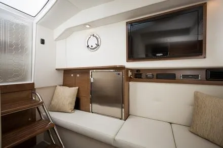 Slide: The Image of Manufacturer Provided Image: Interior of 2015 Cruisers Sport Series 328 Bow Rider with TV, fridge, and seating. - 20