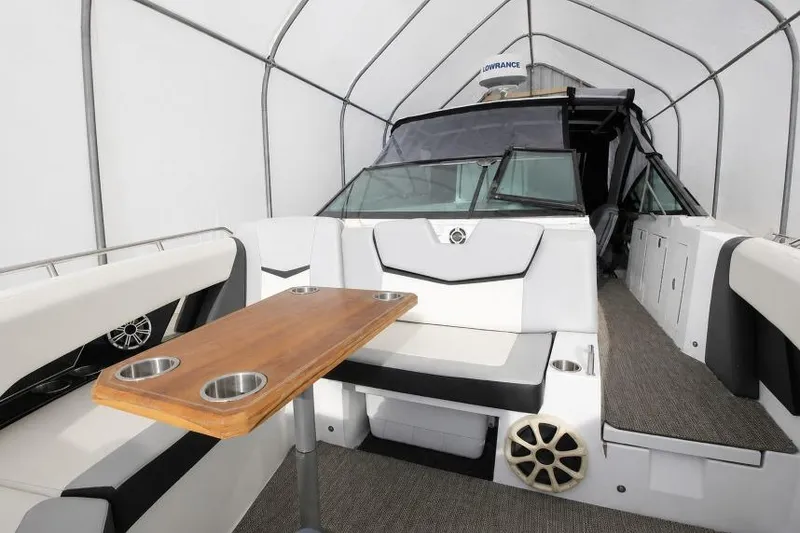 Slide: The Image of 2015 Cruisers Sport Series 328 Bow Rider interior with seating and wooden table. - 4