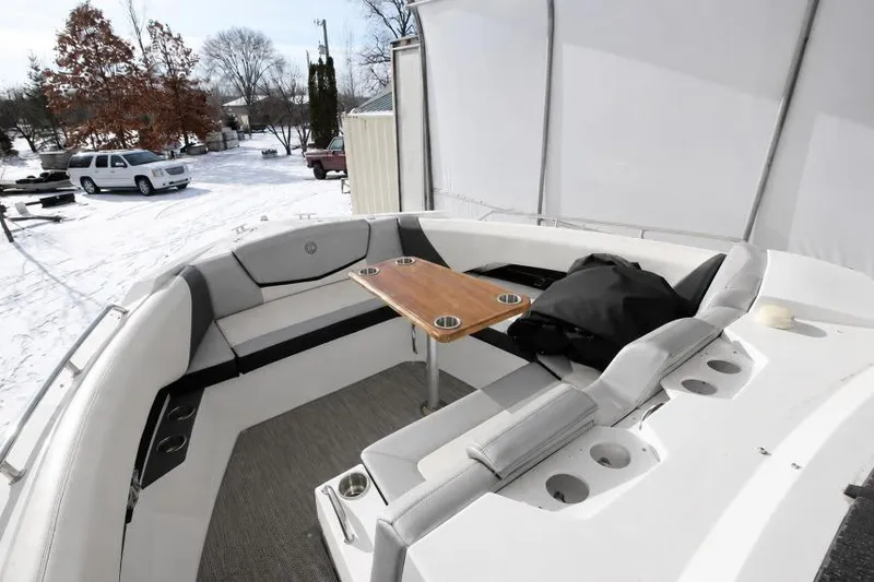 Slide: The Image of 2015 Cruisers Sport Series 328 Bow Rider interior with seating and table in snowy setting. - 5