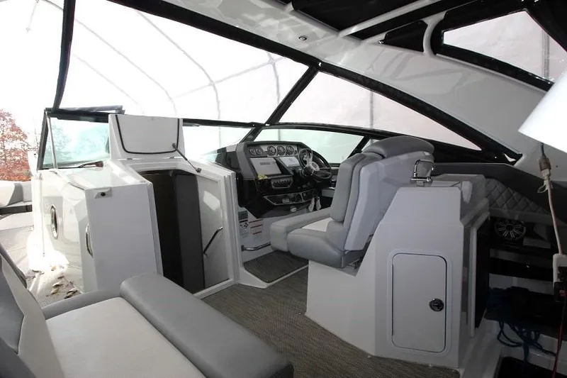 Slide: The Image of Interior of 2015 Cruisers Sport Series 328 Bow Rider boat, featuring helm and seating area. - 6