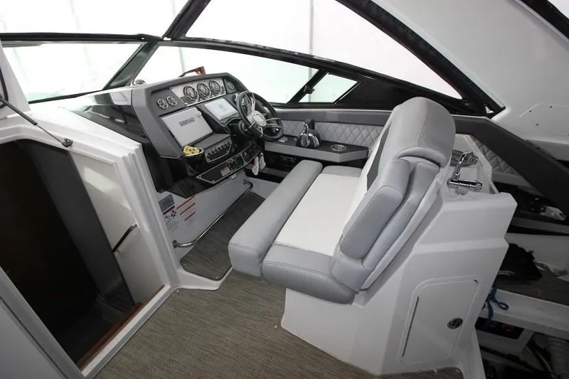 Slide: The Image of Interior of 2015 Cruisers Sport Series 328 Bow Rider boat cockpit with helm and seating. - 7