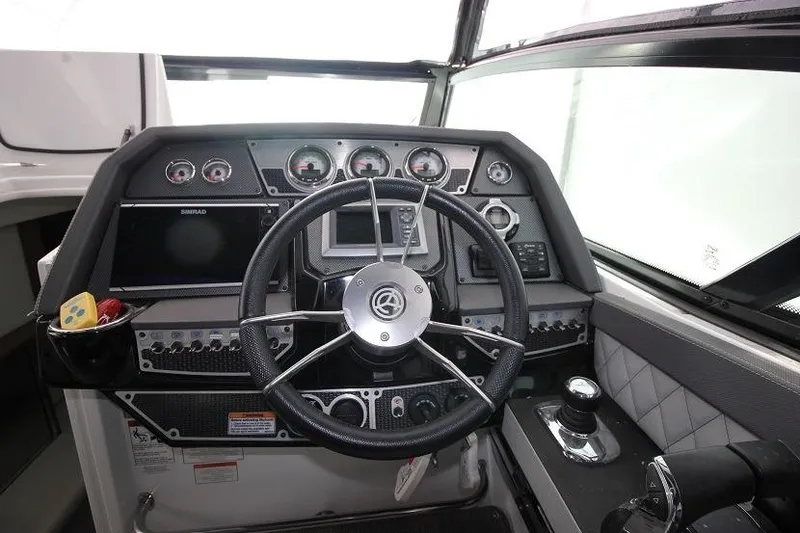Slide: The Image of 2015 Cruisers Sport Series 328 Bow Rider dashboard with steering wheel and control panel. - 8