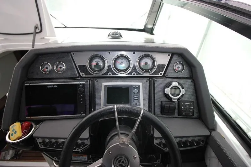 Slide: The Image of 2015 Cruisers Sport Series 328 Bow Rider dashboard with gauges and navigation controls. - 9