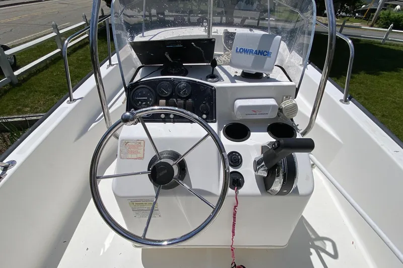Slide: The Image of 2004 Boston Whaler 170 Montauk boat console with steering wheel and navigation equipment. - 4