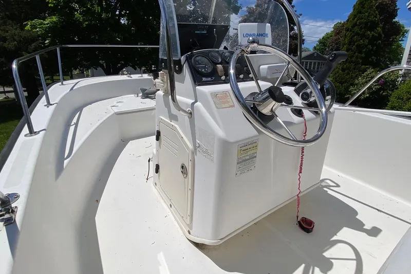 Slide: The Image of 2004 Boston Whaler 170 Montauk boat console with steering wheel and controls. - 5