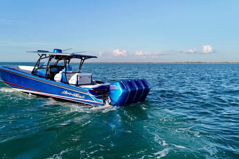 Slide: The Image of 2026 Nor-Tech 390 Sport Center Console boat cruising on open water. - 10