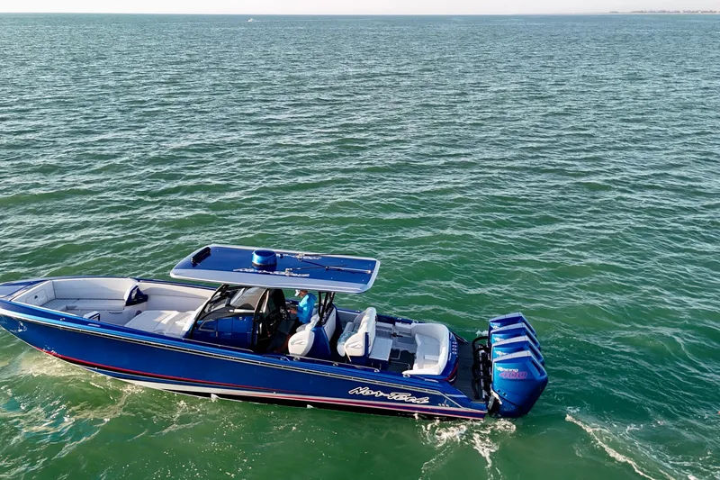 Slide: The Image of 2026 Nor-Tech 390 Sport Center Console boat cruising on open water. - 12