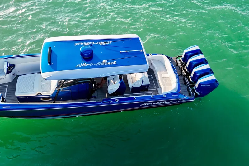 Slide: The Image of 2026 Nor-Tech 390 Sport Center Console boat on clear green water, aerial view. - 14