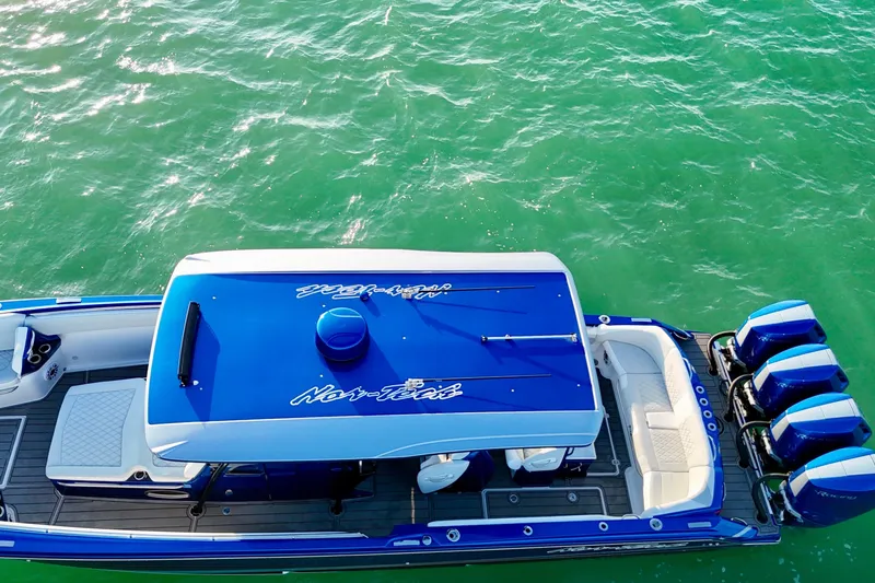 Slide: The Image of Aerial view of 2026 Nor-Tech 390 Sport Center Console boat on green water. - 15