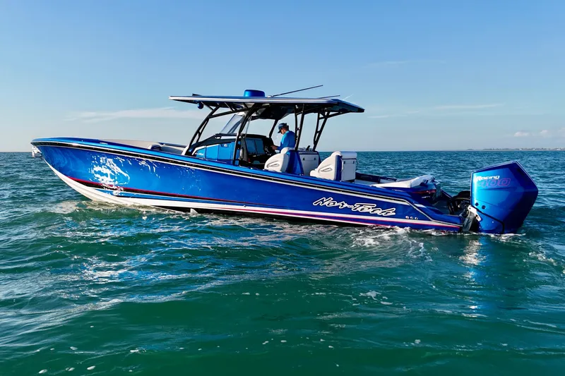 Slide: The Image of 2026 Nor-Tech 390 Sport Center Console boat cruising on open water. - 2