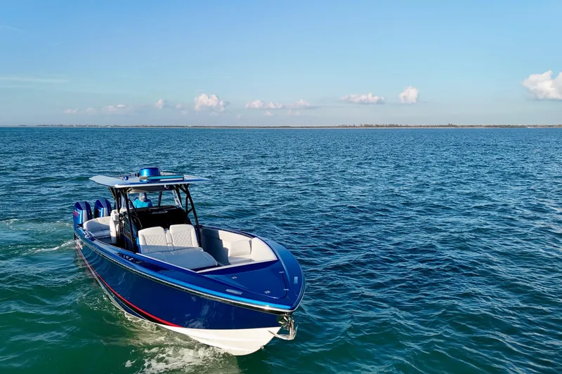 Slide: The Image of 2026 Nor-Tech 390 Sport Center Console boat cruising on open water under clear skies. - 21