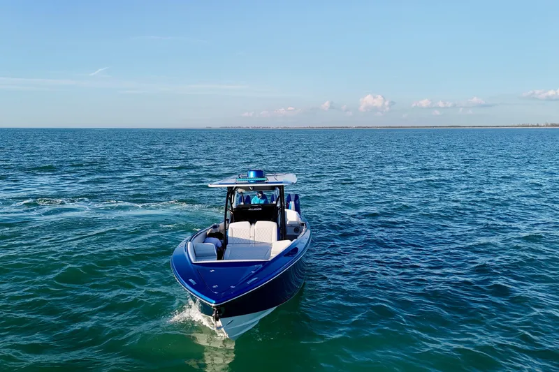 Slide: The Image of 2026 Nor-Tech 390 Sport Center Console cruising on open blue water. - 22
