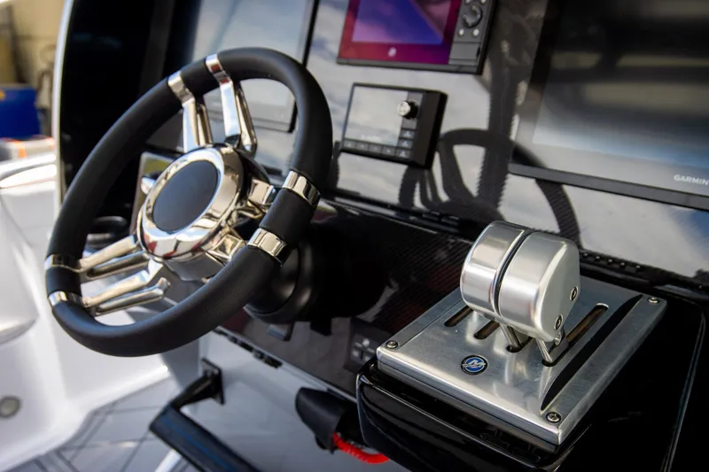 Slide: The Image of Manufacturer Provided Image: Steering wheel and controls of 2026 Nor-Tech 390 Sport Center Console boat. - 27