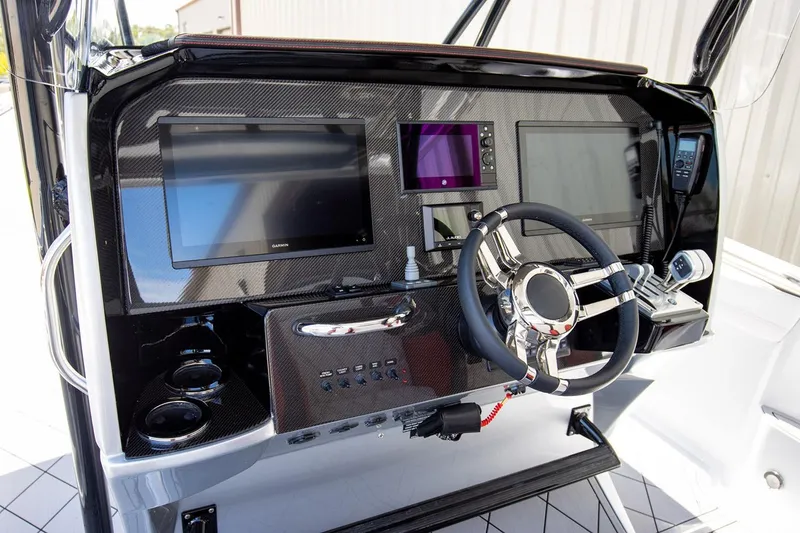 Slide: The Image of Manufacturer Provided Image: 2026 Nor-Tech 390 Sport Center Console dashboard with advanced navigation displays and steering wheel. - 28
