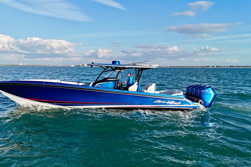 Slide: The Image of 2026 Nor-Tech 390 Sport Center Console boat cruising on open water. - 5