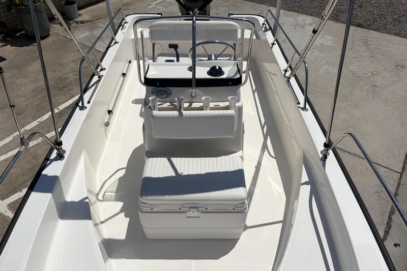 Slide: The Image of 2012 Boston Whaler 170 Montauk boat interior with steering console and seating. - 11