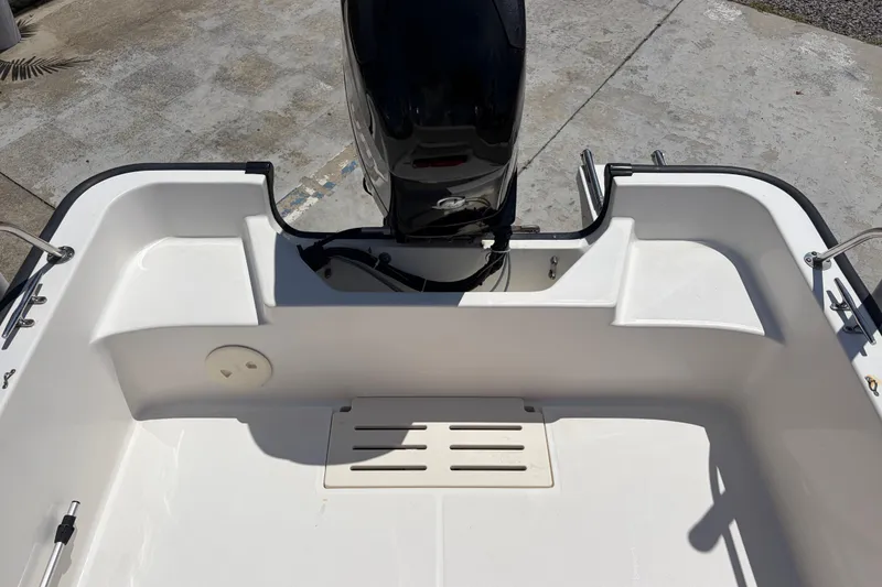 Slide: The Image of 2012 Boston Whaler 170 Montauk boat interior with motor, showcasing clean design and functionality. - 14