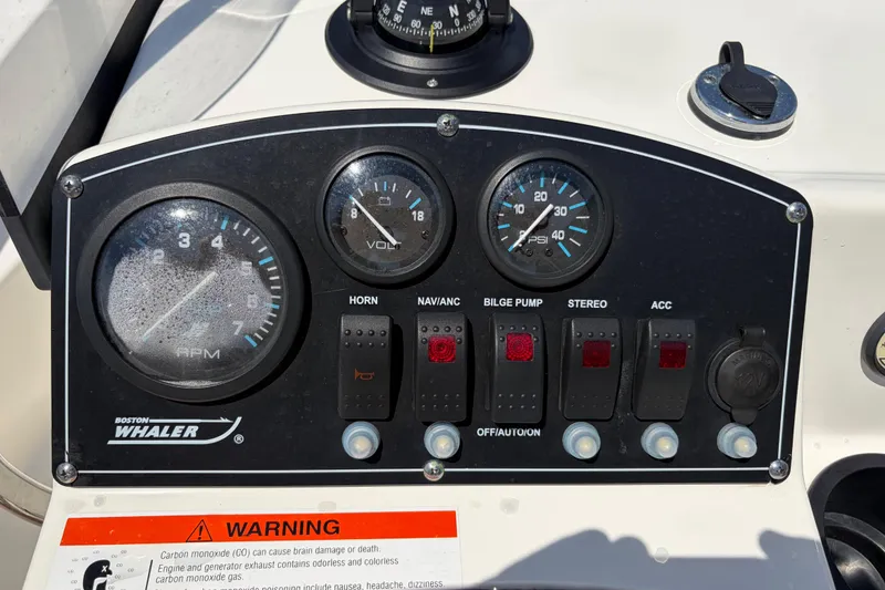 Slide: The Image of Control panel of a 2012 Boston Whaler 170 Montauk boat with gauges and switches. - 17