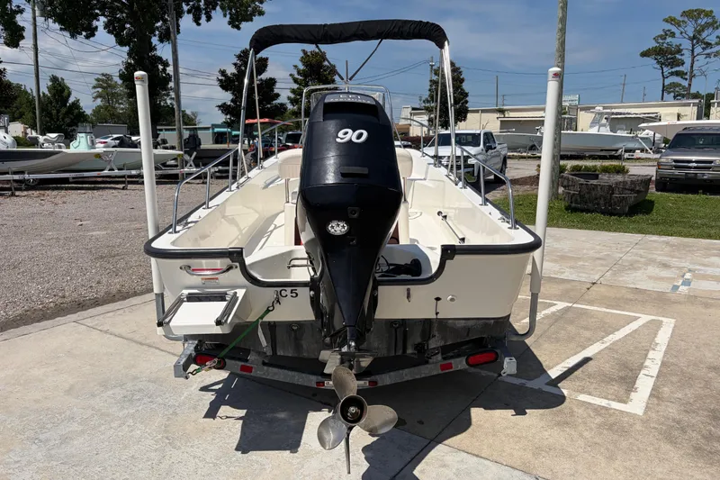 Slide: The Image of 2012 Boston Whaler 170 Montauk boat with 90 HP engine, parked outdoors. - 3