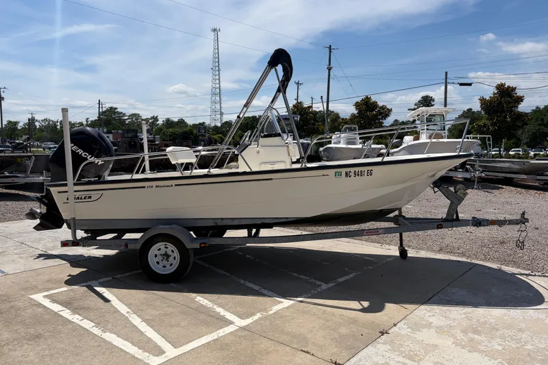 Slide: The Image of 2012 Boston Whaler 170 Montauk boat on trailer in outdoor setting. - 5