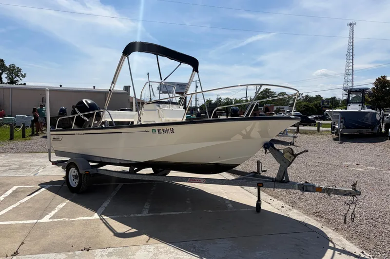Slide: The Image of 2012 Boston Whaler 170 Montauk boat on trailer in outdoor setting. - 6